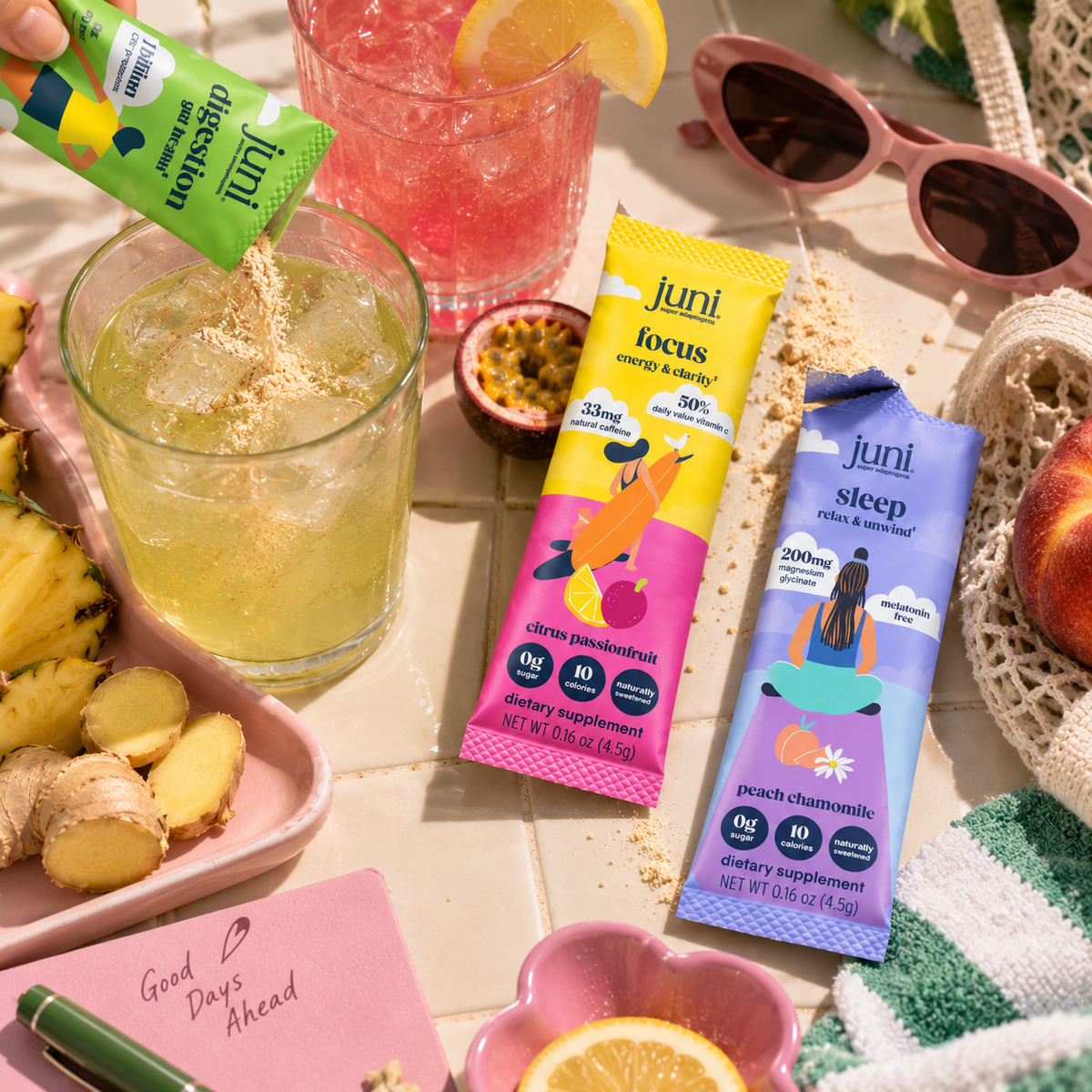 Juni Digestion, Focus and Sleep stick packs on a sunlit table with drinks and fresh fruit